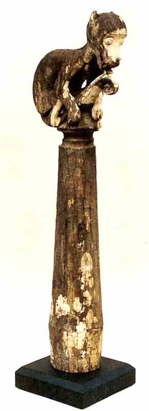 33: Wood Post with Simian Figure? Licking Its Tail